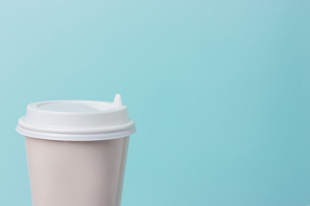 Coffee paper cup isolated on light blue background