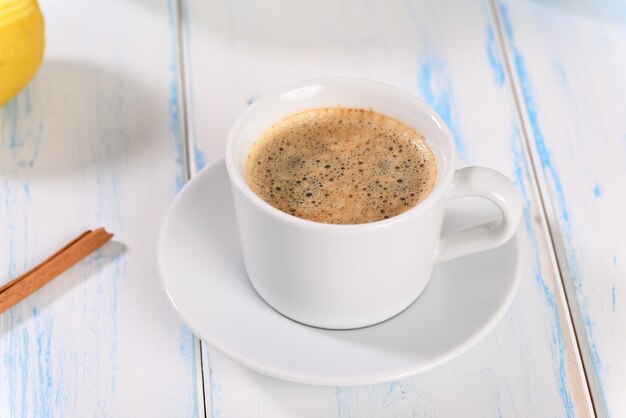 Coffee in porcelain on a white wooden table