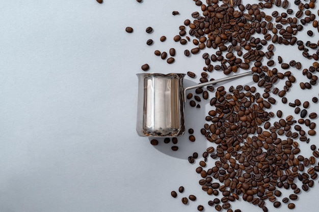 Coffee pot with coffee beans on paper background