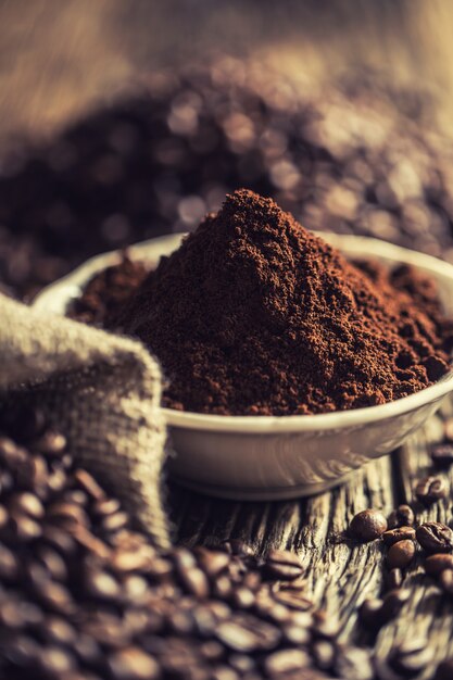 Coffee powder  in white bowl with beans.