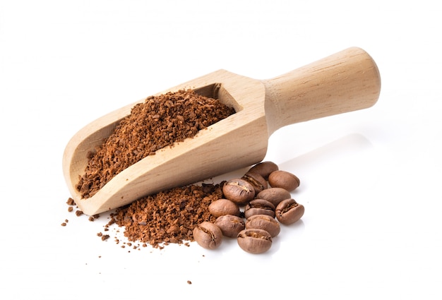 Coffee powder in wood scoop isolated on white