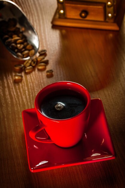 Coffee in red cup on wood board