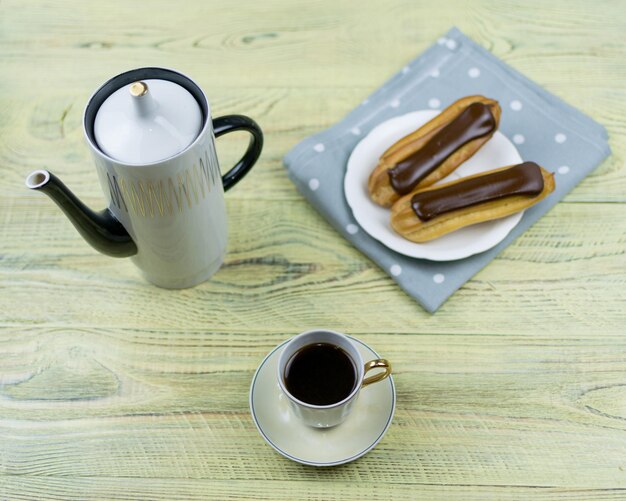 Coffee in a retro cup and cake on a wooden background