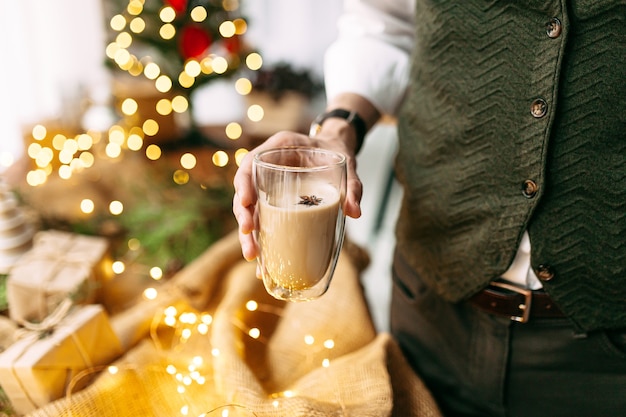 coffee on sackcloth with garland lights and spruce branches