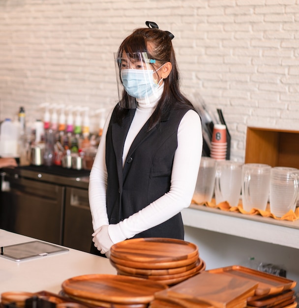 Coffee shop business owner wearing surgical mask  Confident business  woman