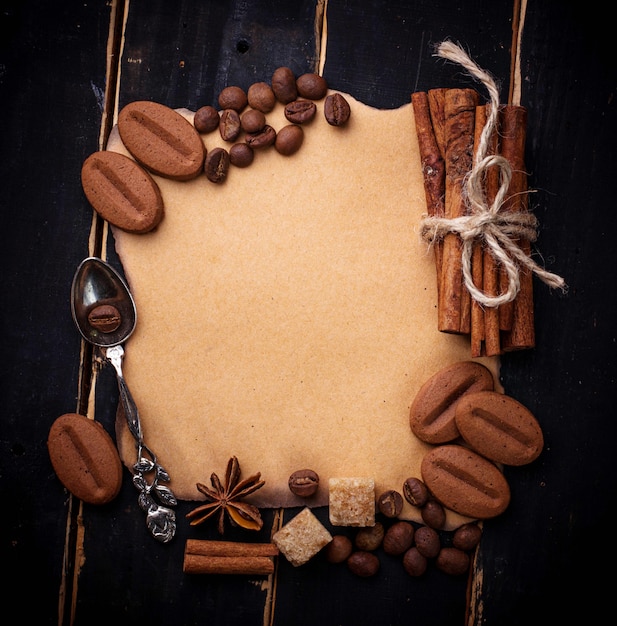 Coffee, sugar, cinnamon, cookies and vintage paper. Selective focus, space for text