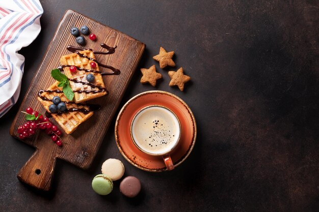 Coffee sweets and waffles with berries