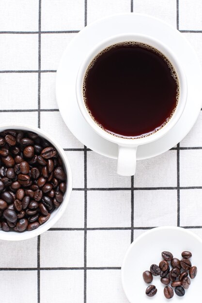 Coffee on the table white coffee on the table and coffee beans as a component