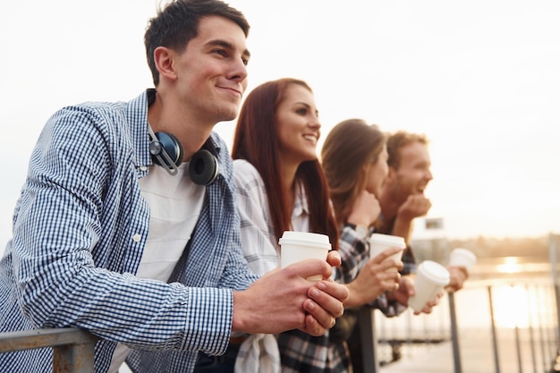 Coffee time Group of young cheerful friends that is outdoors having fun together