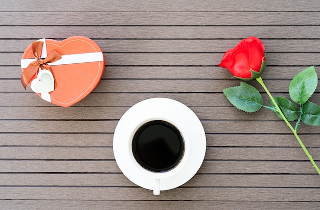 Coffee time with coffee cup, red rose