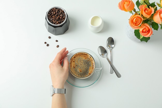 Coffee time with female hand on white background