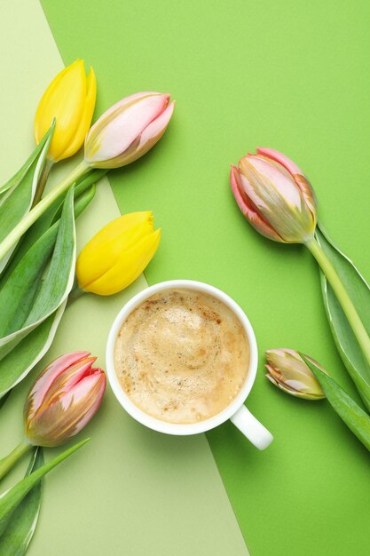 Coffee and tulips on two tone background