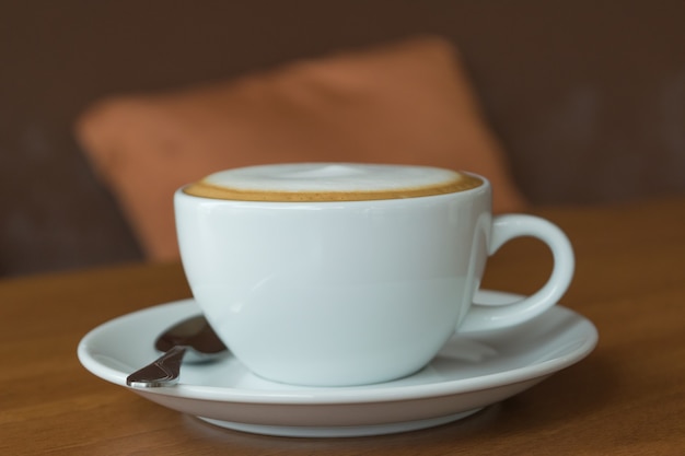 Coffee in white cup on wood table