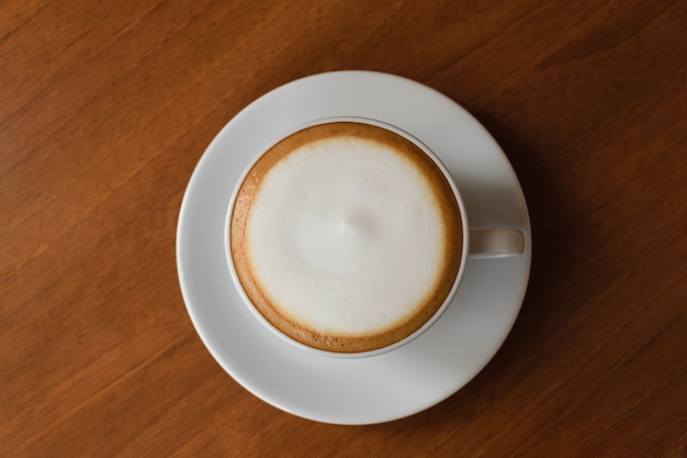 Coffee in white cup on wood table