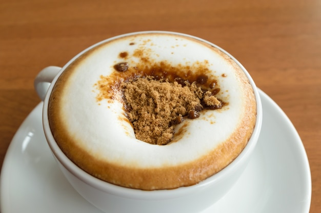 Coffee in white cup on wood table