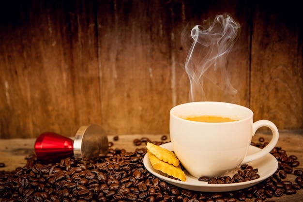 Coffee with coffee bean on wooden background and wooden table