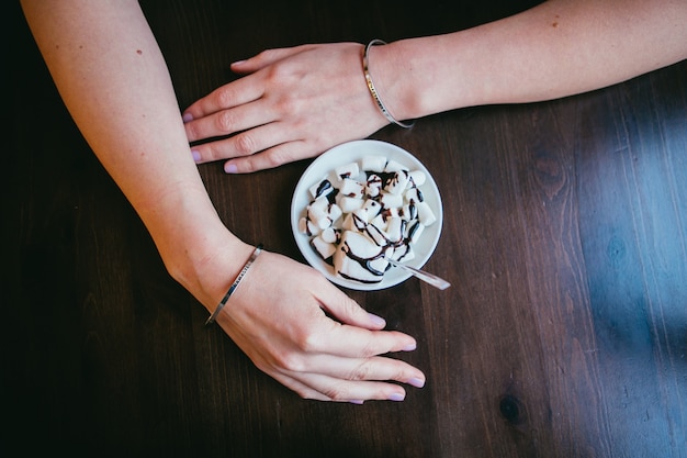 Caffè con schiuma sul tavolo con le mani