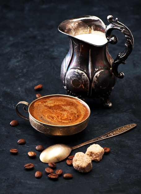 Coffee with milk on a black vintage background