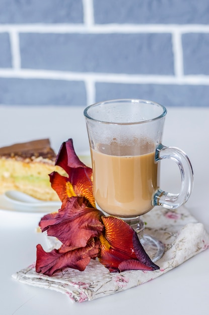 Coffee with milk and cake on a plate