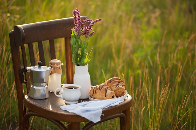 Coffee with milk and croissants. Breakfast at dawn.