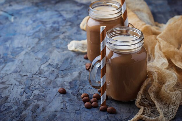 Coffee with milk in jar. Selective focus