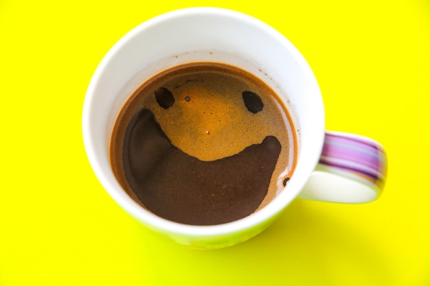 Coffee with a smile from the foam. Funny photo.