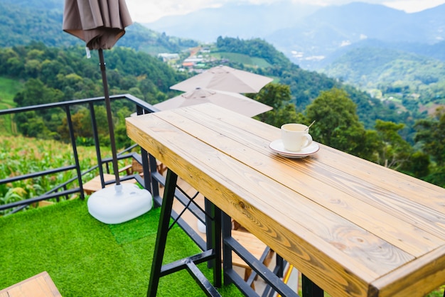 Coffee on wood table at mountain view