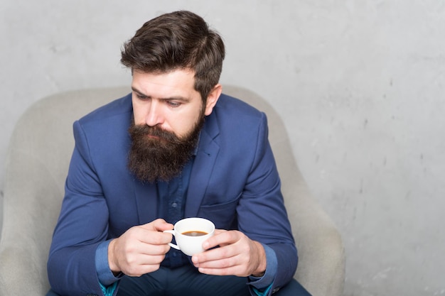 The coffee you can rely on Businessman drinking coffee in the morning Bearded man enjoying his coffee break Hipster holding coffee cup copy space