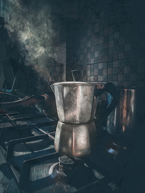 Photo coffeemaker with coffee boils and emits steam on the gascooker