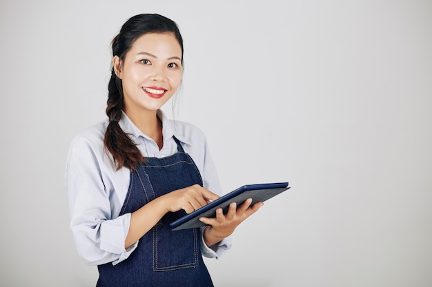 Coffeeshop owner using tablet computer