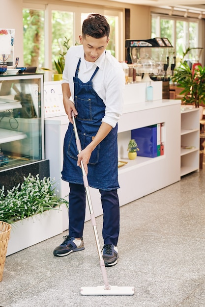 Coffeeshop owner wiping floor