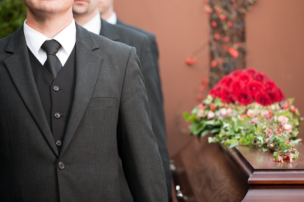 Coffin bearer carrying casket at funeral