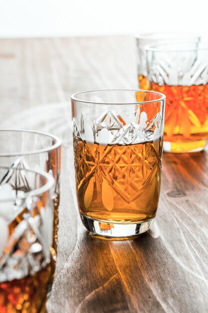 Cognac in crystal wine glasses on a wooden table