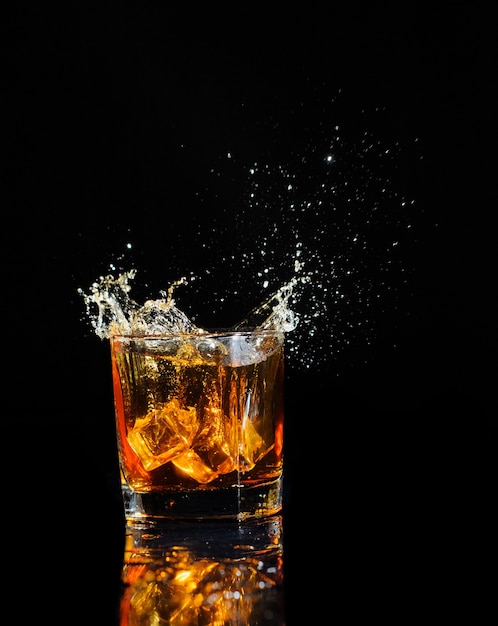 Cognac splashing with ice isolated