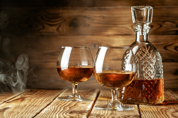 Cognac or whiskey in glasses on rustic backgrpund