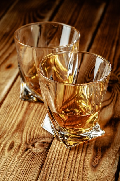 Cognac or whiskey in glasses on rustic table