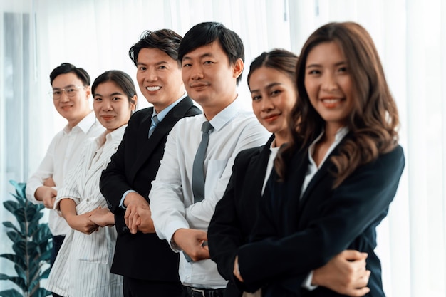 Cohesive office workers holding hand in line to promote harmony in workplace
