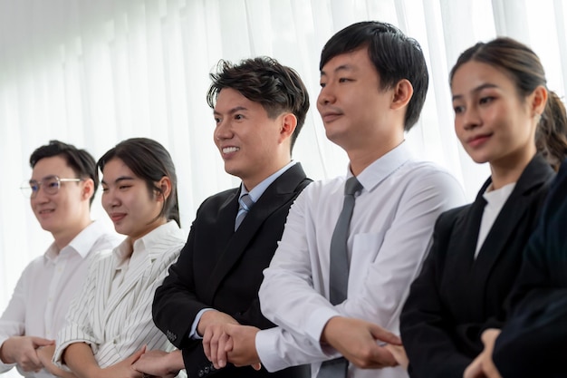 Cohesive office workers holding hand in line to promote harmony in workplace