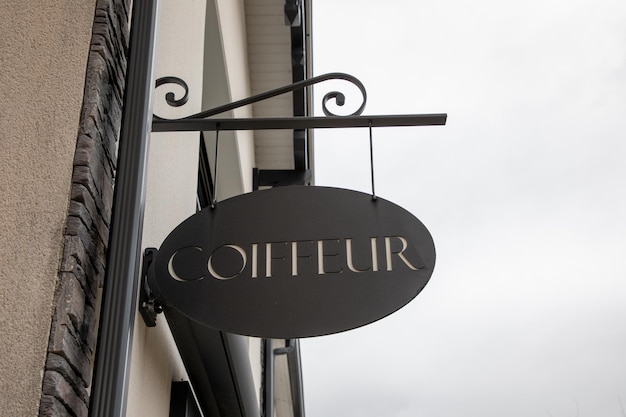 Photo coiffeur french text hairstyle translated into hairdresser barber shop on sign wall facade entrance