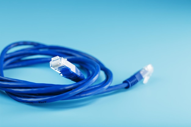 A coil of an Internet network cable for data transmission on a blue background