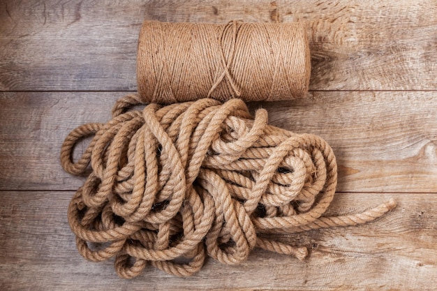 A coil of thin manila rope and a bunch of thick rope lie on the laminate