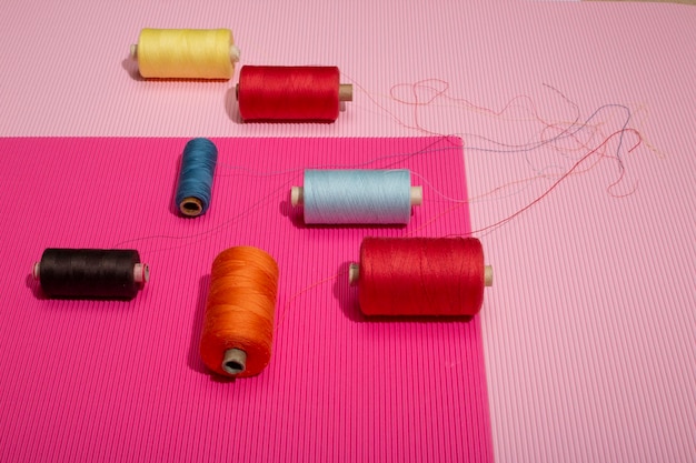 Coils of multicolored threads on a colored background