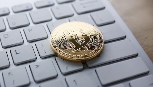 Coin crypto currency bitcoin lies on the keyboard