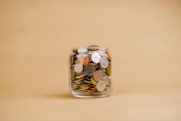 Coin money in a glass jar Saving money Money saving concept coin collection