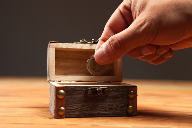 Photo coin and old small chest on the table