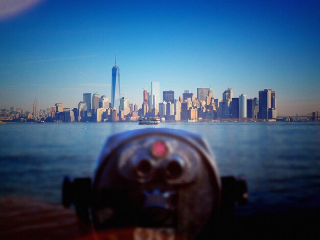 Photo coin-operated binoculars with cityscape in background