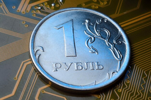 A coin with a face value of 1 ruble lies on a microcircuit closeup Translation of the inscription on the coin quot1 rublequot The concept of the digital economy in the Russian Federation