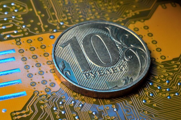 A coin with a face value of 10 rubles lies on a microcircuit closeup Translation of the inscription on the coin quot10 rublesquot The concept of the digital economy in the Russian Federation