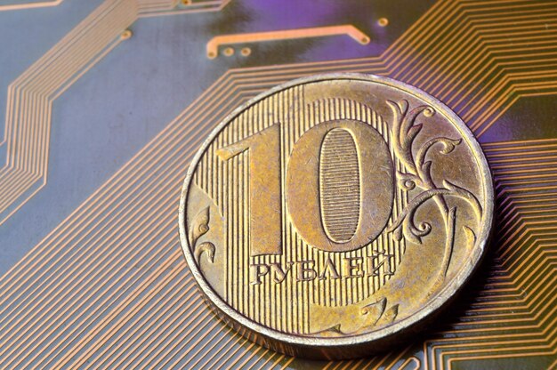 A coin with a face value of 10 rubles lies on a microcircuit closeup Translation of the inscription on the coin quot10 rublesquot The concept of the digital economy in the Russian Federation