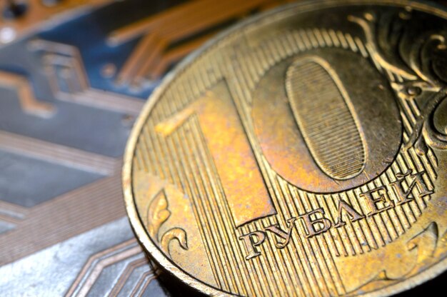 A coin with a face value of 10 rubles lies on a microcircuit closeup Translation of the inscription on the coin quot10 rublesquot The concept of the digital economy in the Russian Federation